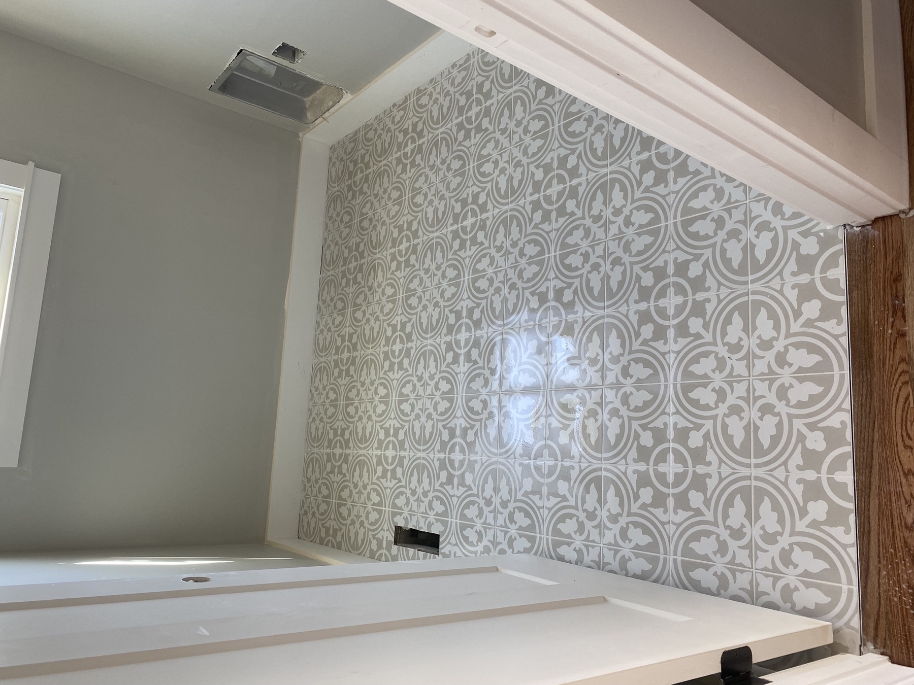 Patterned encaustic-style porcelain floor tile in a laundry room