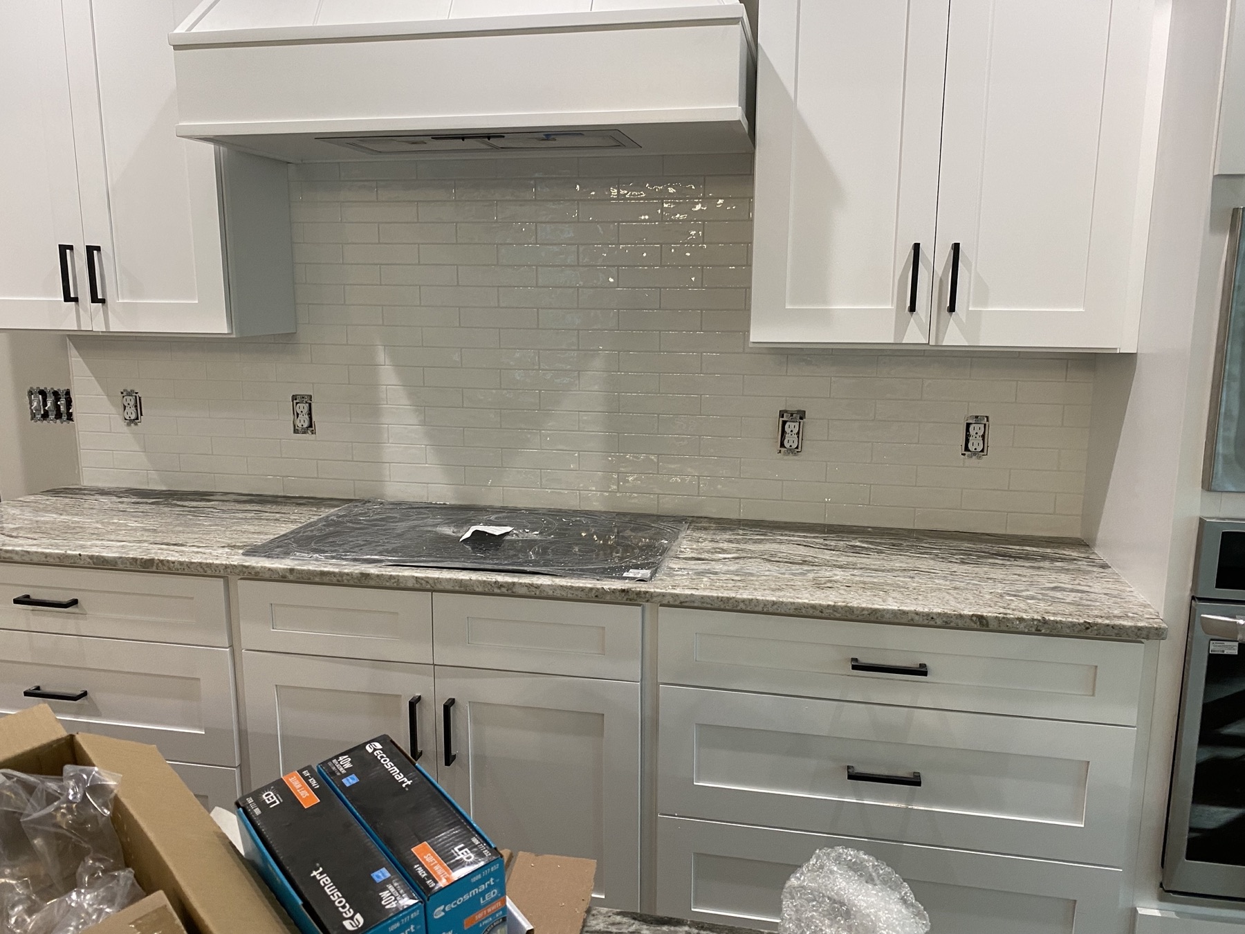 White subway tile kitchen backsplash with stone countertop