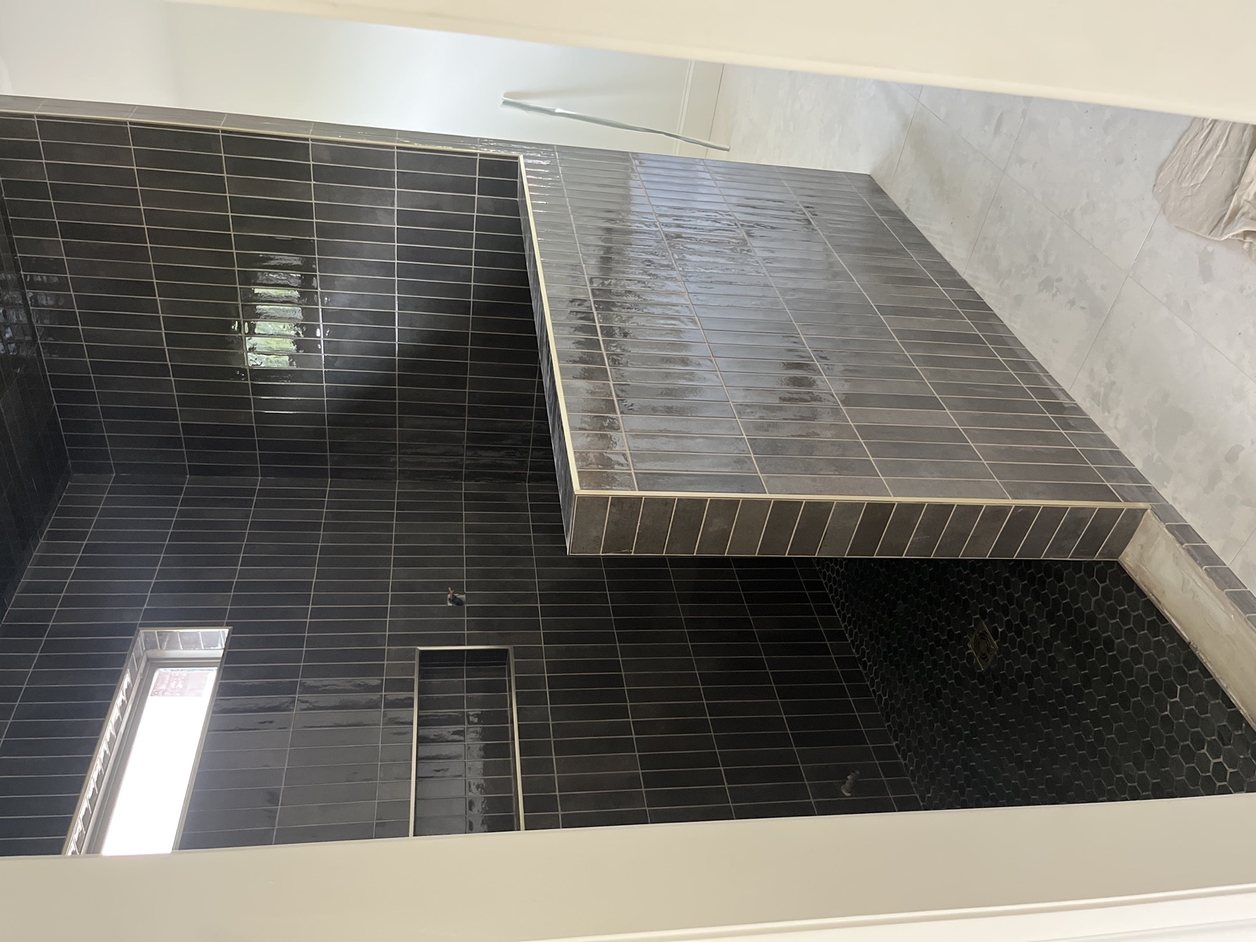 Walk-in shower · vertical charcoal tile